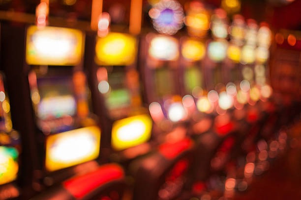 Dealer at live baccarat table with cards and betting layout visible